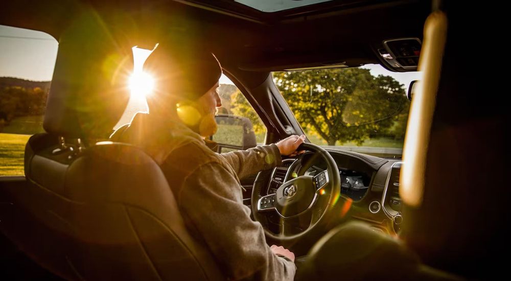 A person is shown driving a 2024 Ram 2500.