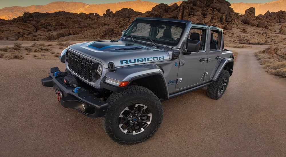 A grey 2024 Jeep Wrangler 4xe Rubicon parked in the desert.