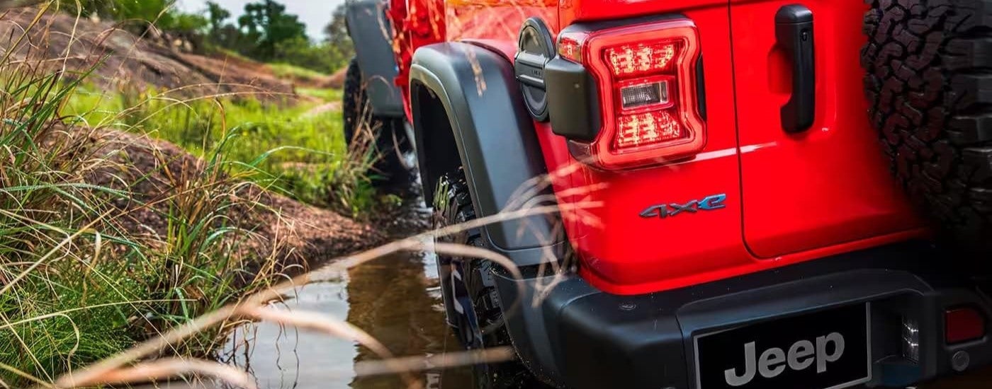 A close-up on the taillight of a red 2024 Jeep Wrangler 4xe.