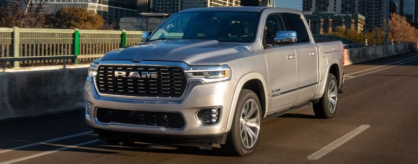 A silver 2025 Ram 1500 for sale is shown from the front at an angle.